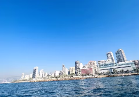 A waterfront city skyline beneath a clear blue sky